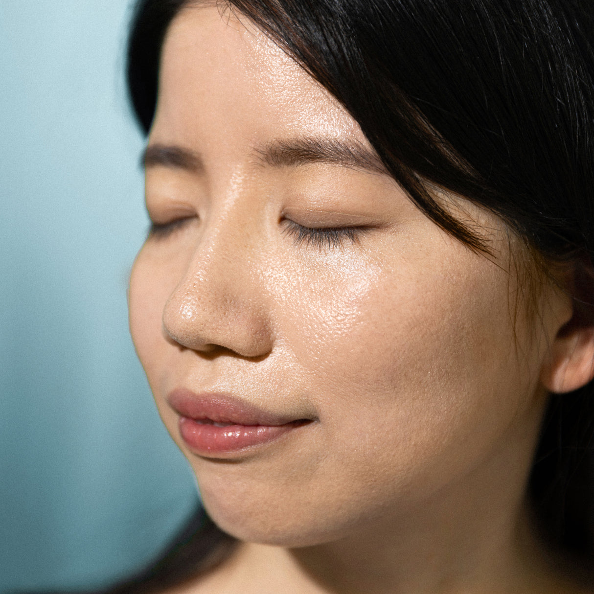 Model close up glowing skin after applying Antipodes sunscreen