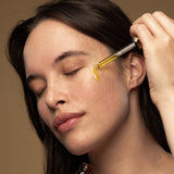 Model applying Antipodes rosehip and avocado face oil with dropper
