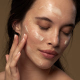 Model applying Antipodes Avocado Pear Nourishing Night Cream on face