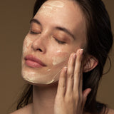 Model applying Antipodes Manuka honey face mask on skin