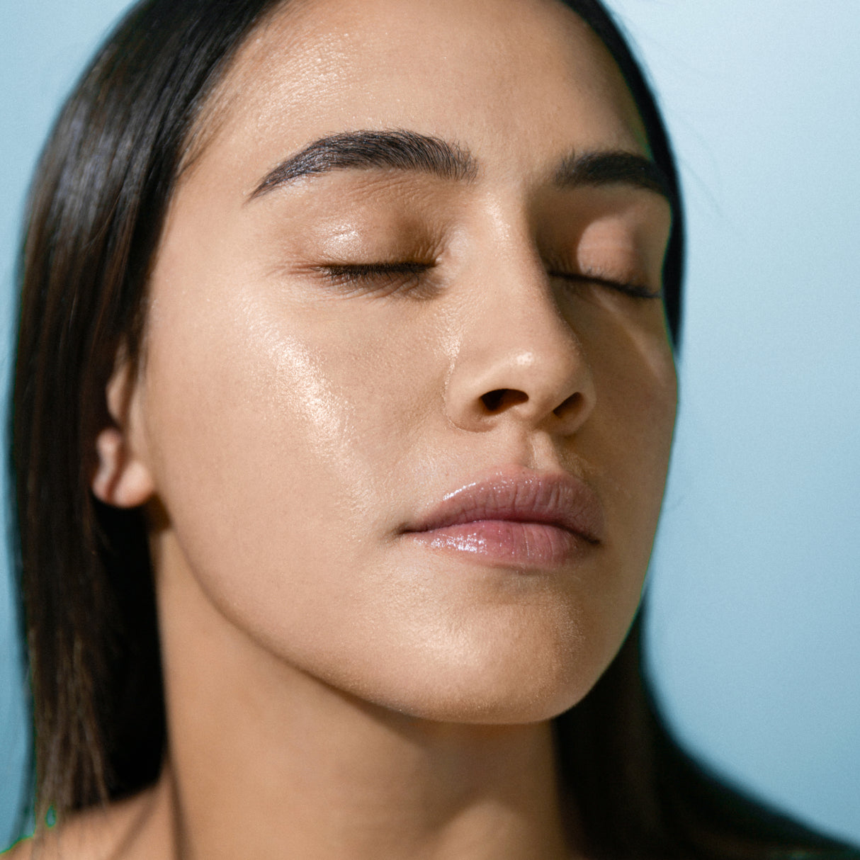 Model wearing Antipodes Supernatural SPF50 sunscreen natural skin finish
