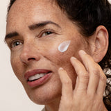 Model applying Antipodes Jasmine Flower Menopause Facial Cream on face