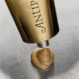 Antipodes Aura Gold Manuka Honey Radiance Mask being dispensed from tube showing texture