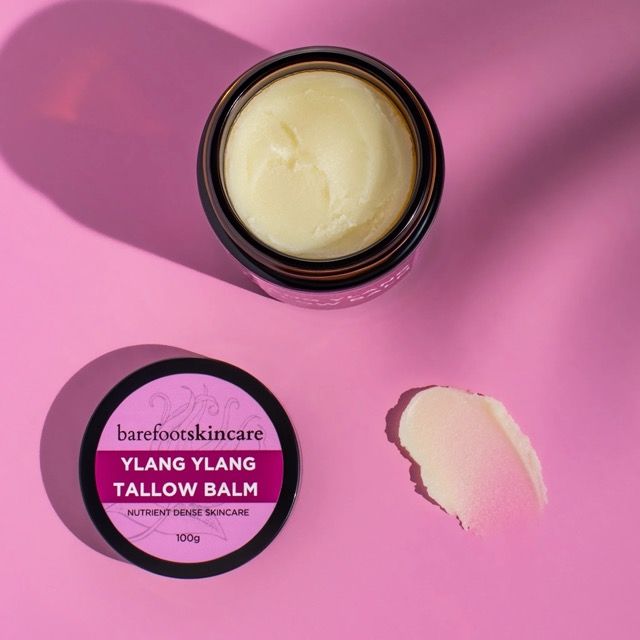 Barefoot Skincare Ylang Ylang Tallow Balm jar with balm texture swatch on pink background