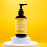 Barefoot Skincare Tallow Body Lotion pump bottle displayed on stand with bright yellow background